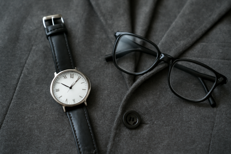 montre simple lunettes posées sur veste